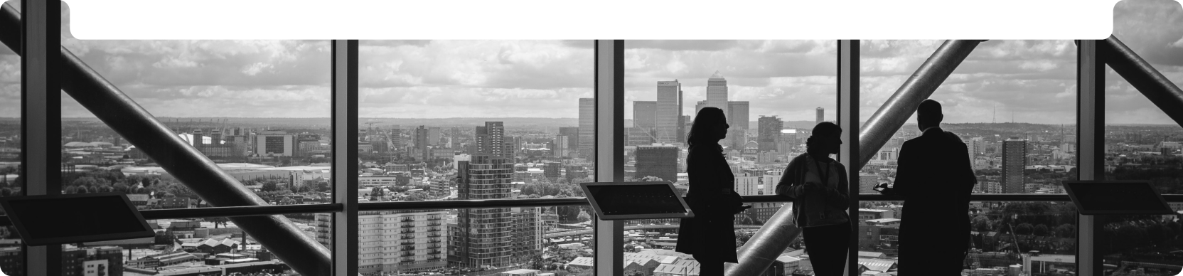 Some people standing by a large window